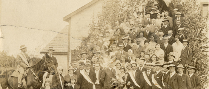 A group of people posing outside a decorated barn